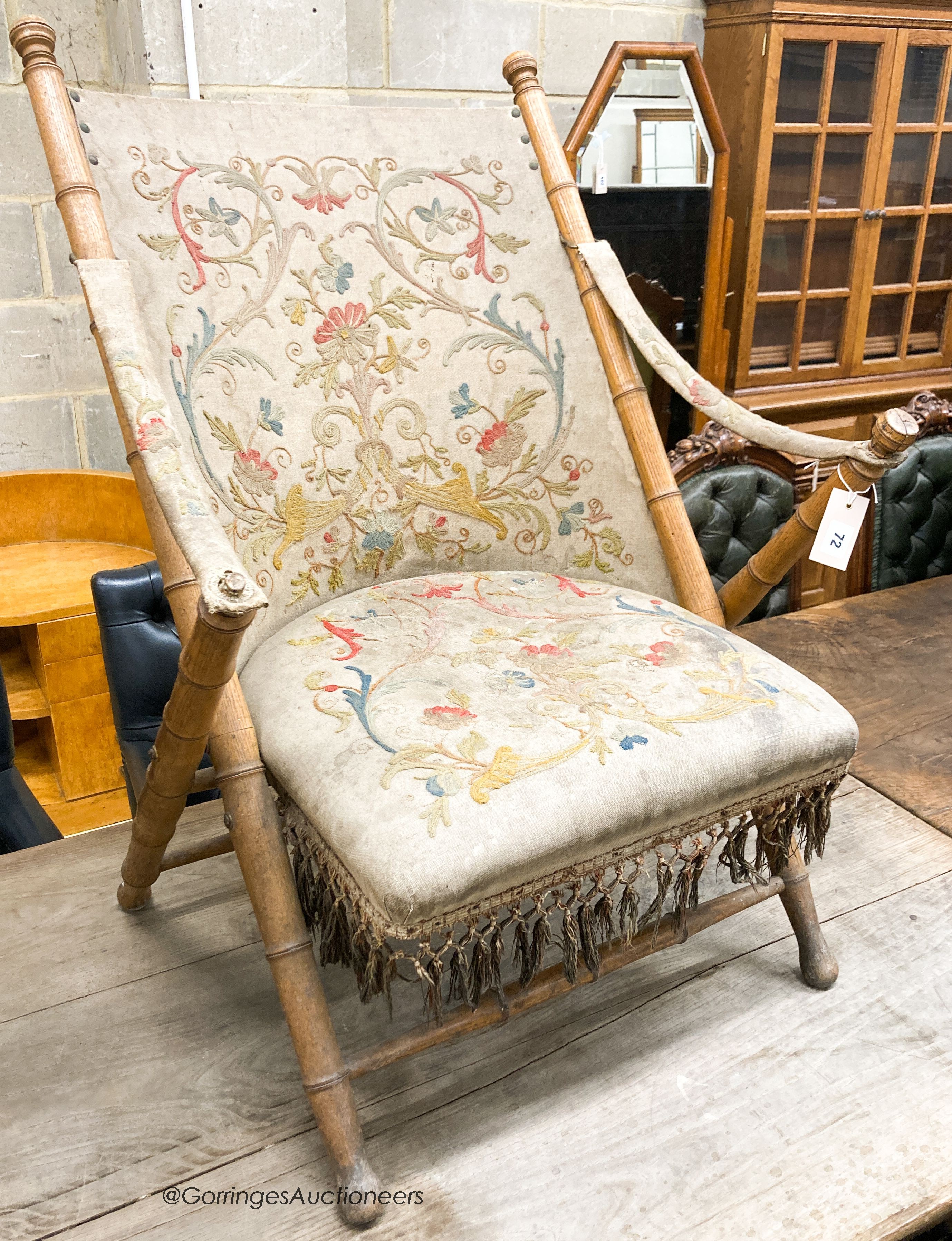 A Victorian faux bamboo folding chair with tapestry upholstery, W.66cm D.50cm H.90cm